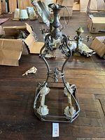Chandelier frame dismantled showing metal leaf motifs and four light sockets
