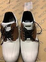 Pair of men's Hi-Tec golf shoes seen from above showing white leather and brown side panels with black laces, never worn.