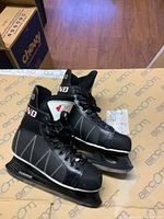 Pair of men's Ferland F1000 ice skates side view showing overall condition and design details.