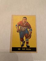 Front of 1960 Parkhurst Bill Hicke hockey card showing player in Montreal Canadiens uniform with yellow background and black nameplate.