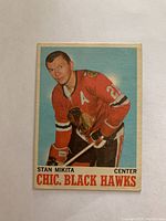 Front side of 1970/71 O-Pee-Chee Stan Mikita hockey card, showing player in red Chicago Black Hawks jersey with letter A and club logo on shoulder.