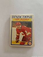 Stack of 1982/83 OPC hockey cards featuring Lanny McDonald in red Calgary Flames uniform with 'In Action' text.