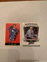 Two hockey cards side by side on a white background, one signed by Dick Duff and the other by Brendan Bell.