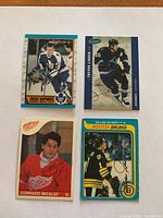 Four hockey cards featuring Vincent Damphousse, Trevor Linden, Corrado Micalef, and Gilles Gilbert, all autographed.