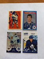 Four autographed hockey cards: one vintage style from Toronto Maple Leafs, one Darryl Boyce card, one Matt Stajan Upper Deck card, and one Christian Hanson Victory Rookie card.