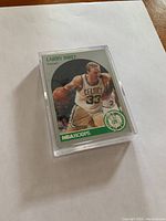 Close-up of Larry Bird NBA Hoops Rookie card in a protective hard plastic case.