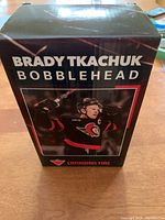 Box of the Brady Tkachuk bobblehead showing branding and product photo