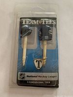 Front view of NHL Team Tees packaging showing two golf tees with Toronto Maple Leafs hockey jersey and helmet toppers and a logo marker tee, all new in sealed plastic packaging.