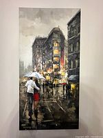 Canvas print showing a rainy city street scene with couple walking under umbrella