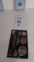 Photo showing Bicentennial coins with certificate inside protective packaging.