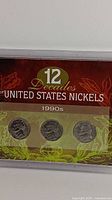 Close-up of the 1990s set showing three nickels on card labeled '12 Decades of United States Nickels'