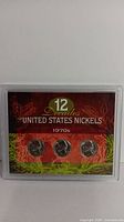 Set of three 1970s nickels in red holder labeled '12 Decades of United States Nickels 1970s'
