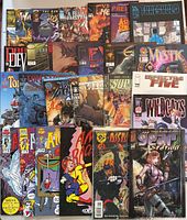 Lot of 25 comics spread out showing mix of superhero, sci-fi and other genres, variety of titles including The Atomics, Tom Strong, Mystic, Wildcats.