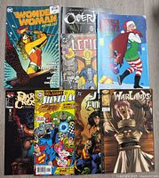 Top view of the 9 comic books laid out in two rows, showcasing the variety and cover art of each comic.