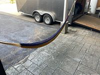 Hammock hung between two points showing its length and multicolor woven fabric.