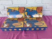 Four factory-sealed Rocky and Bullwinkle stationery boxes arranged on a surface against a white brick wall background.