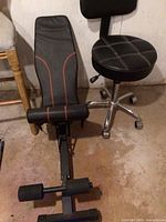 Photo showing black vinyl office stool and black vinyl exercise bench side by side against a wall on a concrete floor.