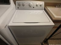 Front view of white Kenmore Series 500 top loading washing machine showing lid and general appearance.