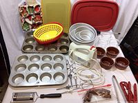 Overview of the kitchen and baking tools and pans including muffin tins, hand mixer, baskets, cookie cutters, ramekins, and accessories.