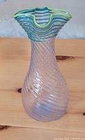 Clear textured glass vase with yellow and green rim