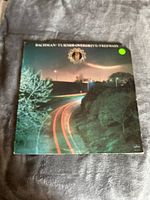 Front cover of Bachman-Turner Overdrive Freeways vinyl LP showing nighttime photo of highway with light trails.