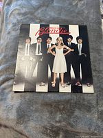 Front cover of Blondie Parallel Lines vinyl album showing band members dressed in black and white against striped background.