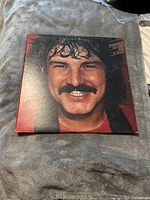 Front cover of Burton Cummings LP showing artist's close-up portrait with mustache and curly hair.