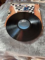 Vinyl LP record cover front with the record partially out showing the label 'Epic'