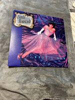 Front cover of the Linda Ronstadt vinyl album "What's New" showing the artist in a pink gown.