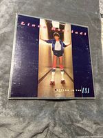 Front cover of Linda Ronstadt 'Living in the USA' vinyl record album with image of Linda in roller skates.