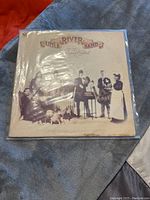 Front cover of Little River Band's Diamantina Cocktail album in plastic sleeve, showing band members and title text.