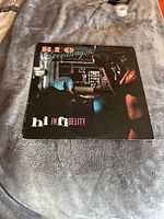 Full front cover of the 'Hi Infidelity' vinyl LP album by REO Speedwagon showing album artwork and title.