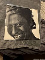 Front cover of Robert Palmer Riptide vinyl album showing full face smiling portrait in black and white.