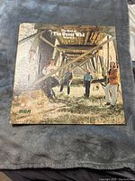 Front cover of The Best of The Guess Who vinyl record album showing band members under wooden bridge.