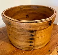 Side view of wooden grain measure bucket showing staved construction and nail joint