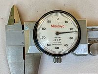 Close-up of dial showing Mitutoyo branding, 0-1" marking, model 505-612, made in Japan