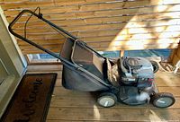 Full side view of Murray gas lawn mower with grass bag attached
