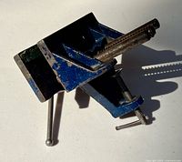 Top angle of blue Mastercraft bench vise showing jaw area and mounting clamp