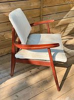 Full view of armchair showing frame, upholstery and design