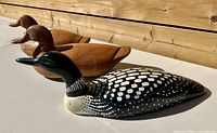 Three decoys side view showing paint and wood grain