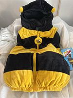 Full view of the toddler bee costume in black and yellow stripes with hood and zipper