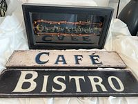 Three wall decor signs displayed, including shadow box and café/bistro metal signs.