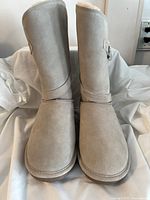 Front view of mushroom-colored Bearpaw boots showing rounded toes and suede-like finish.