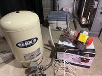 Both pressure tank and pump positioned side by side on concrete floor