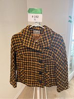 Front view of vintage Sebastian women's short coat in brown and black houndstooth pattern with large buttons and wide collar.