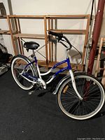 Full side view of the Schwinn Super 3 Cruiser ladies bike showing blue and white frame, high handlebars, comfort seat, dual fenders, and tires.