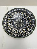 Top view showing the intricate colorful hand-painted floral and geometric design inside the bowl.