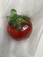 Top view of the red glass strawberry with green stem showing the Nuutajarvi label