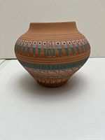 Front view of Navajo pottery vase showing traditional geometric design and perforations near the neck.