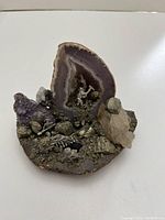 Top view showing natural agate slice with pyrite, quartz crystals and miniature metal mined cart and ladder